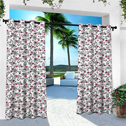 A white and red patio curtain with a palm tree in the background.