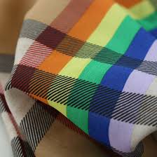 A colorful checkered scarf on a white surface.