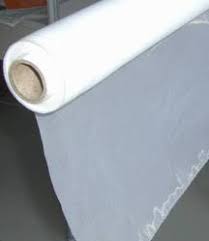 A roll of white cloth sitting on top of a table.