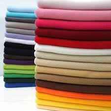 A stack of different colored fabrics stacked on top of each other.