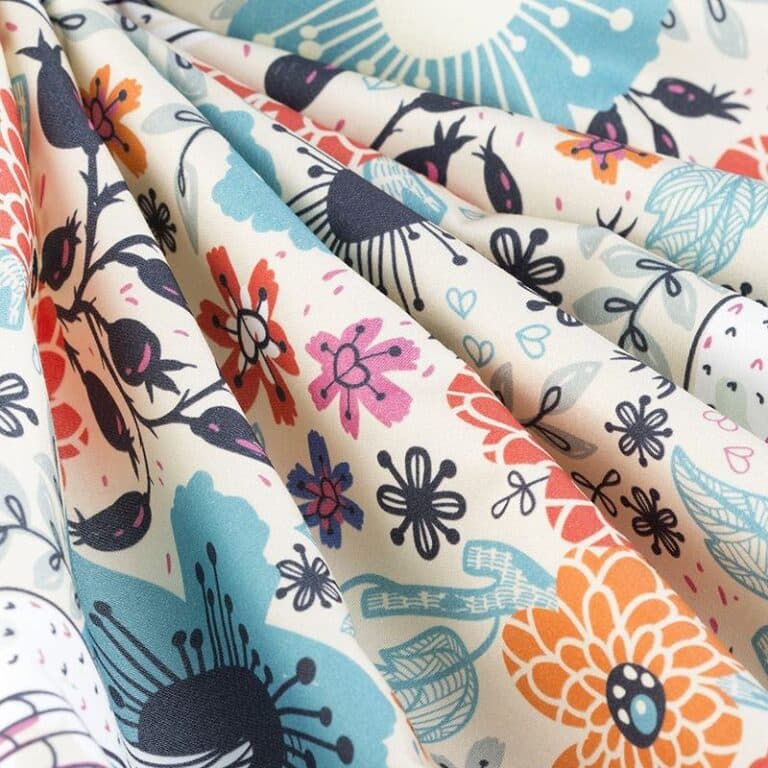 A close up of a fabric with colorful flowers.