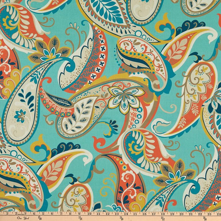 A blue and orange paisley duck fabric with a ruler.