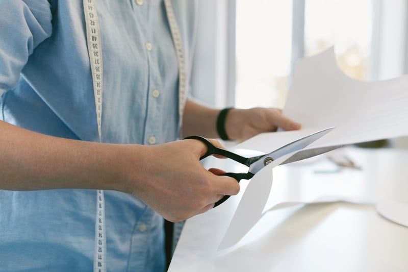 seamstress cutting a pattern